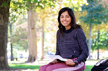 Female Student Studying on Bench