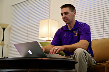 Male Student Using Laptop at Home