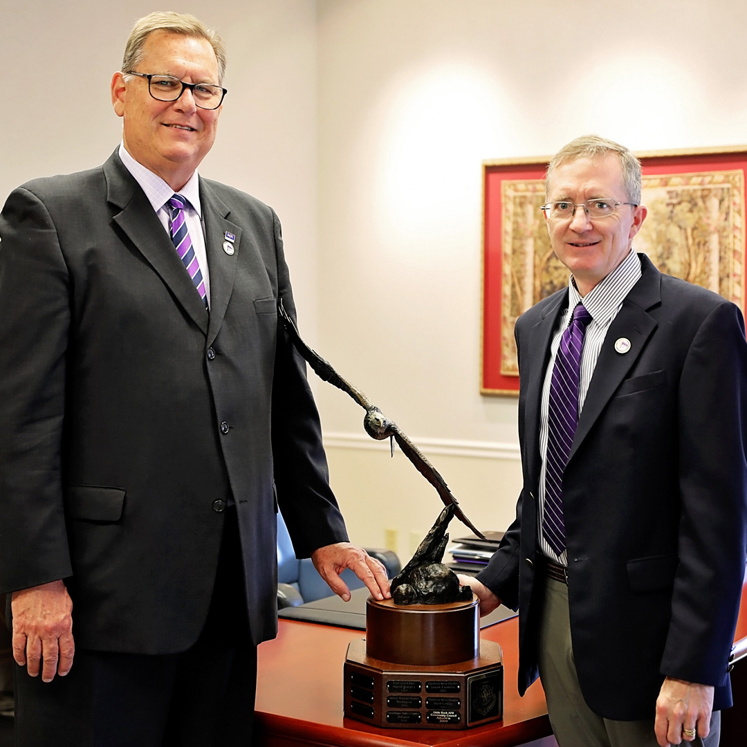 McKendree University President Daniel Dobbins and Vice President of Operations Daryl Hancock, retired U.S. Navy Captain, are pictured with the Abilene Trophy.  