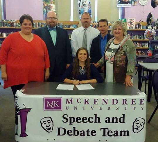 Photo of Eric Scott, Emma Scott and Holly Scott, seated, are joined by Mascoutah High School Principal Sandy Jouglard, McKendree Coach Joe Blasdel.