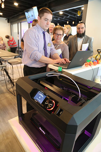 Jonathan Ciembronowicz ’15, systems analyst, demonstrates 3-D printing capabilities to Dr. Janice Wiegmann, professor of nursing, and Dr. Ahed Elmsallati, assistant professor of computing.