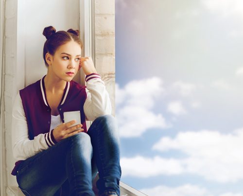 Photo of Female Student Looking Out the Window